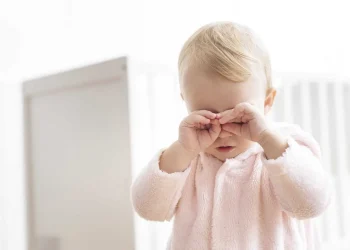 Baby standing eye rub